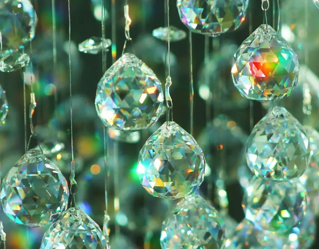 Crystal prisms reflecting light, representing the many dimensions of workplace attitude and employee performance.