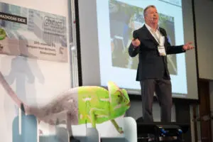 Daniel Ord speaking on stage in Hungary